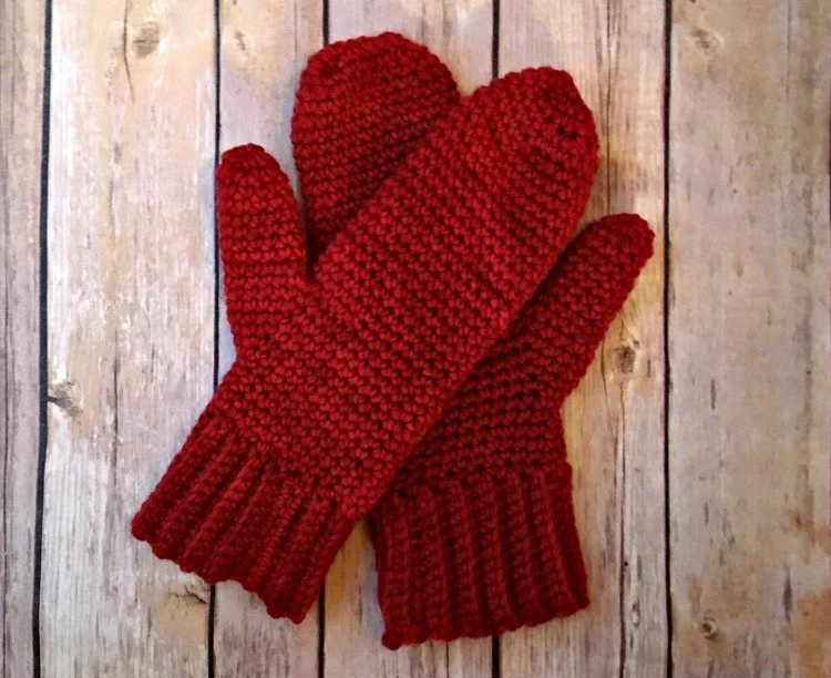 easy crochet mittens lying flat on wooden background