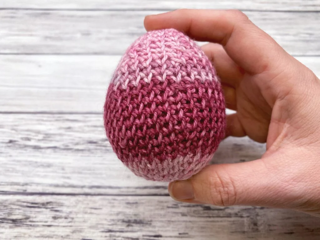 hand holding a crochet easter egg to show scale