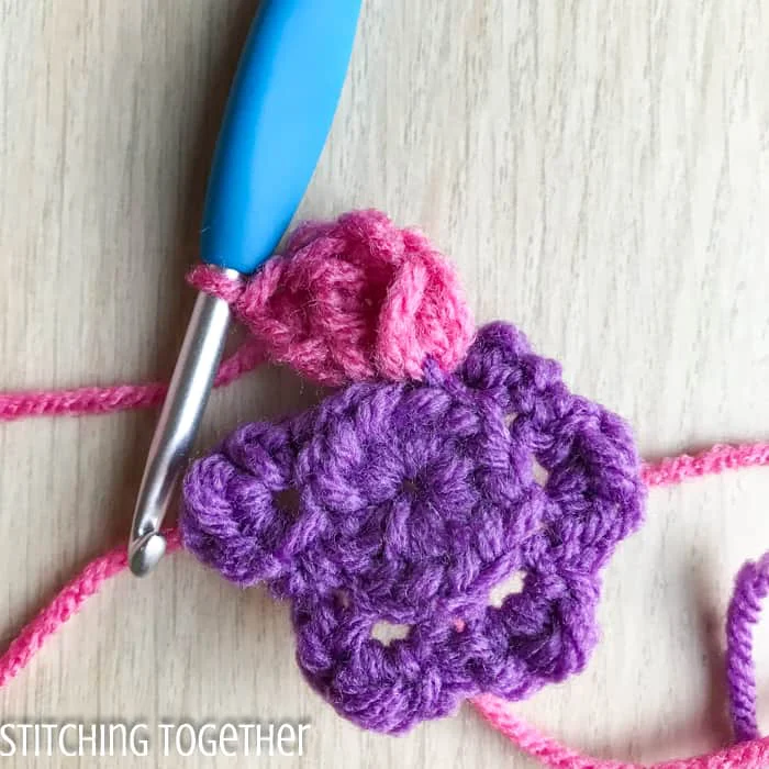 adding crochet petals to a flower